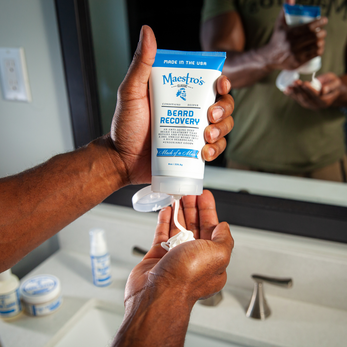 Person applying Maestro's Beard Recovery product in a bathroom setting